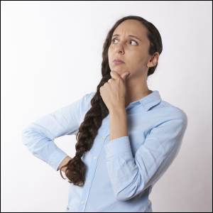 Woman with hand on chin, wondering.