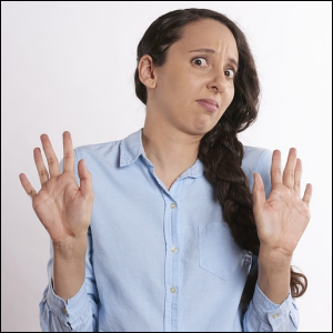 Woman with braid with hands up, refusing or saying no.
