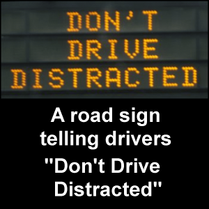 Eliminate distracted driving. Road sign telling drivers 'Don't Drive Distracted'.